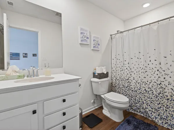 a bathroom with a toilet a sink and a mirror