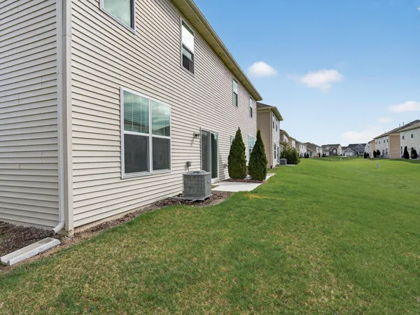 a view of a house with backyard and sitting area