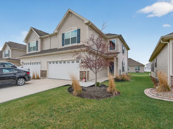 a view of a house with a yard and garage