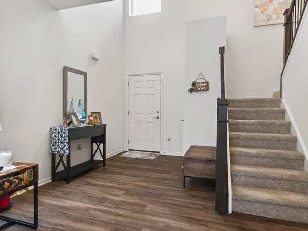 a view of a livingroom with wooden floor and furniture