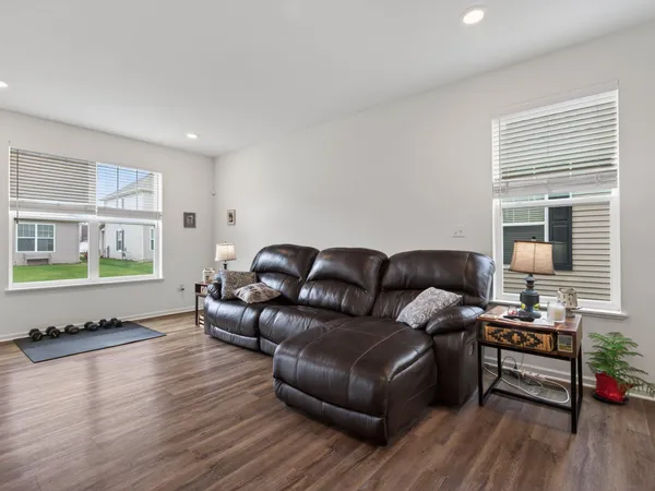 a living room with furniture and a wooden floor