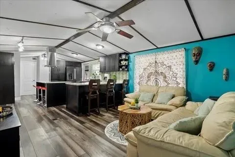 a living room with furniture kitchen and a table