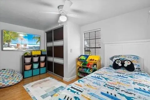 a bedroom with a bed and wooden floor