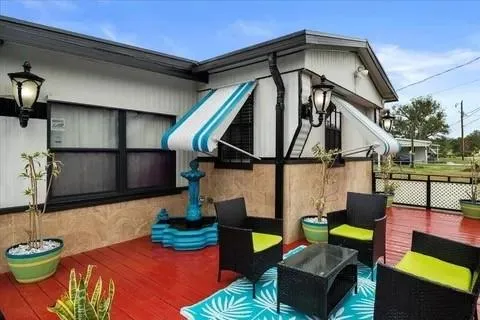 a view of outdoor living space with dining table and chairs