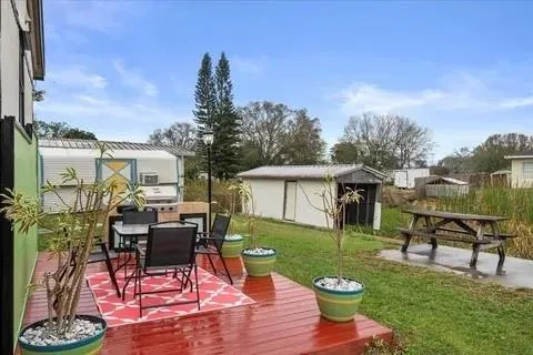 a view of a house with backyard sitting area and garden