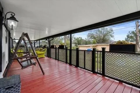 a view of a balcony with wooden floor