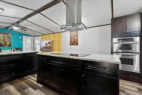 a kitchen with a sink appliances and cabinets