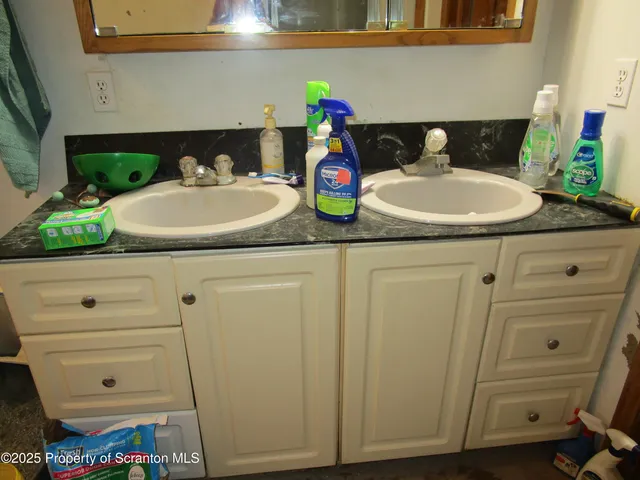 a bathroom with a sink a toilet and a mirror