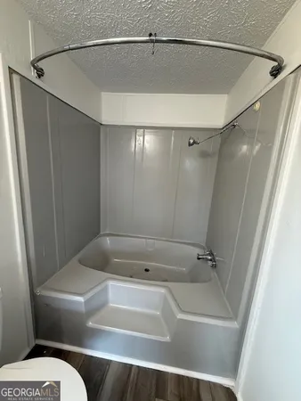 a bathroom with a tub and shower