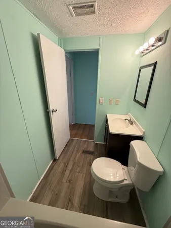 a bathroom with a toilet a sink and a mirror