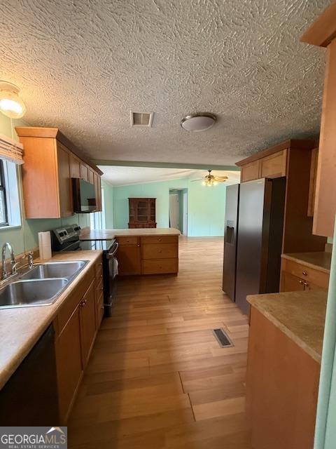 2791 Old Mill Road Rutledge, GA 30663 - Photo 10 of 26 a large kitchen with stainless steel appliances a large counter top a stove a chimney a sink and dishwasher