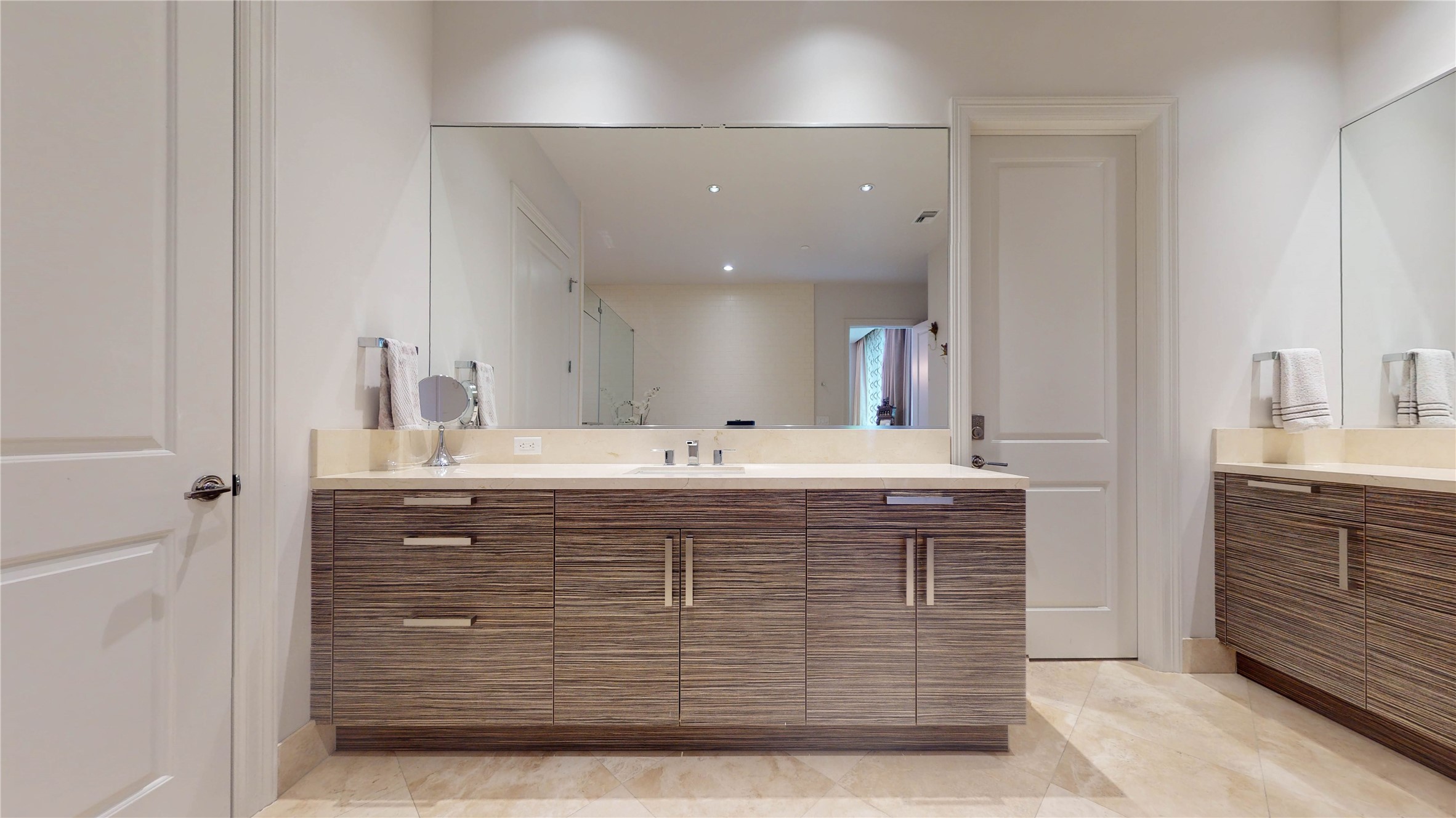 1409 Post Oak Boulevard, Unit 902 Houston, TX 77056 - Photo 12 of 38 a bathroom with a sink vanity and mirror