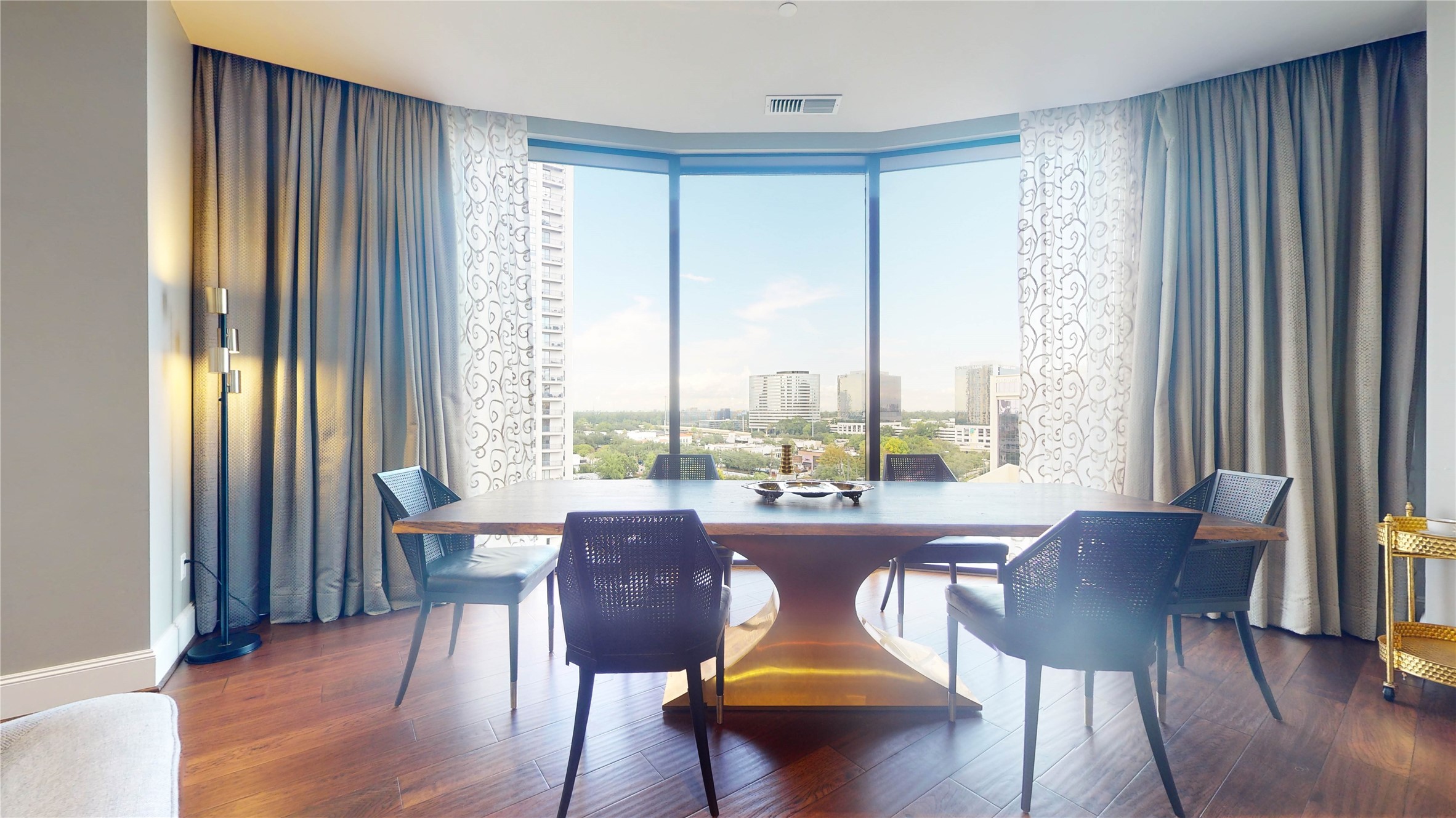 1409 Post Oak Boulevard, Unit 902 Houston, TX 77056 - Photo 14 of 38 a view of a dining room with furniture and wooden floor