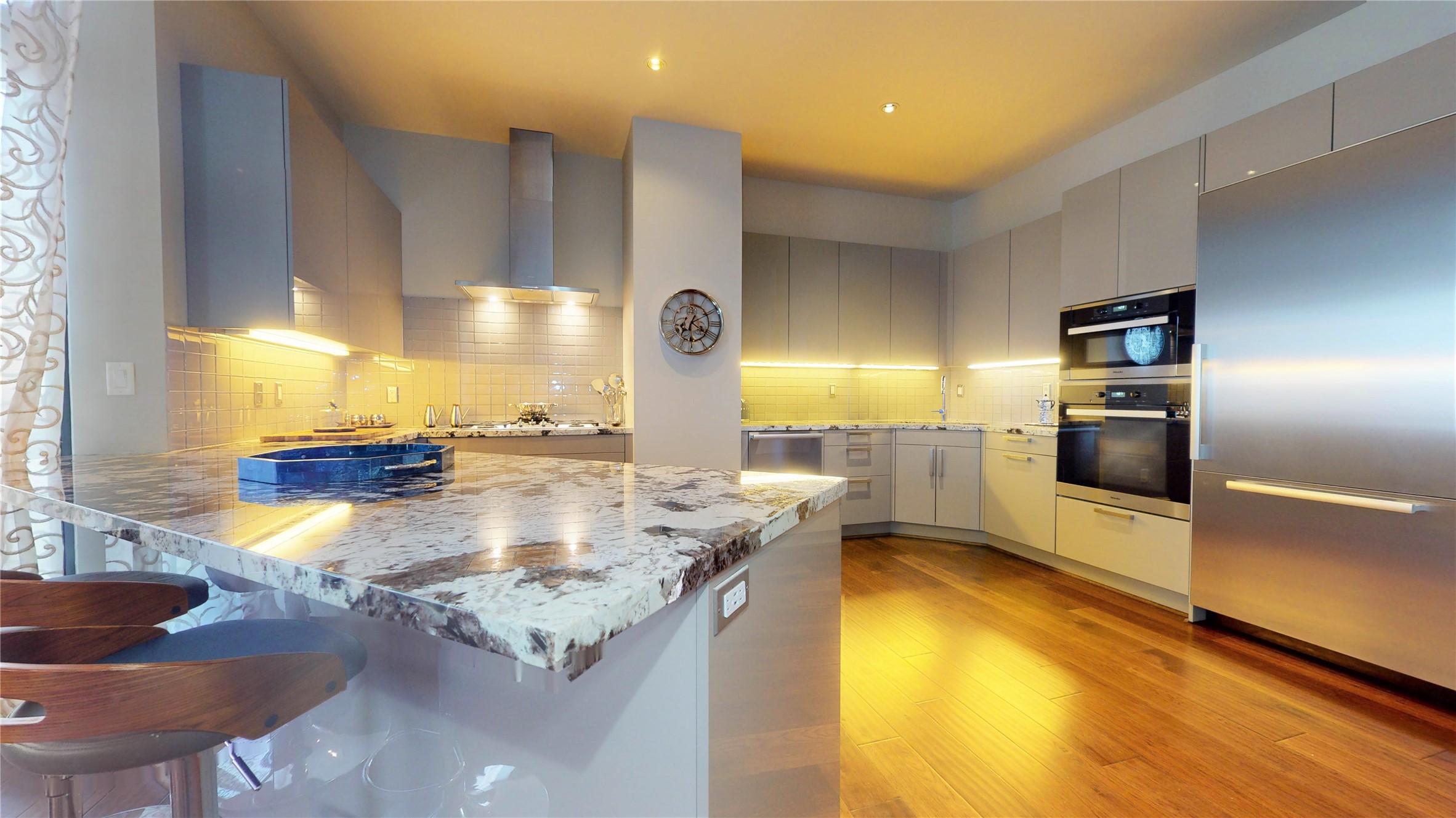 1409 Post Oak Boulevard, Unit 902 Houston, TX 77056 - Photo 18 of 38 a kitchen with stainless steel appliances granite countertop a sink and a stove