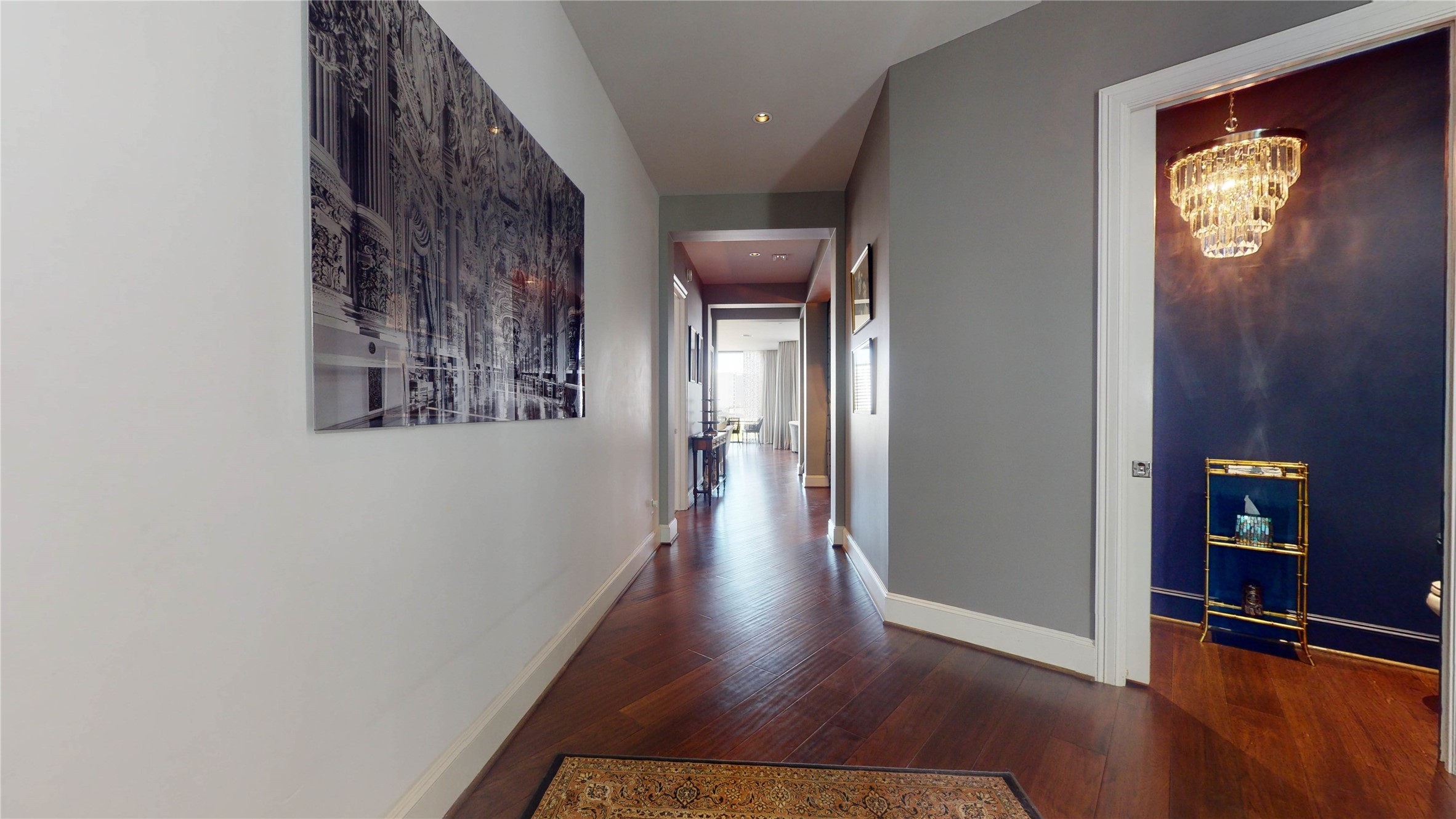 1409 Post Oak Boulevard, Unit 902 Houston, TX 77056 - Photo 7 of 38 a view of a hallway with wooden floor and a living room