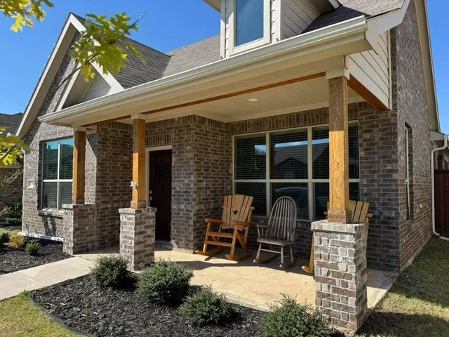 a front view of a house with large windows