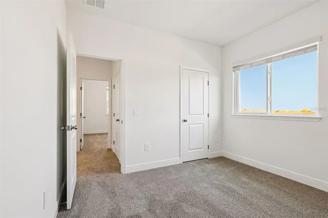 an empty room with windows and entrance