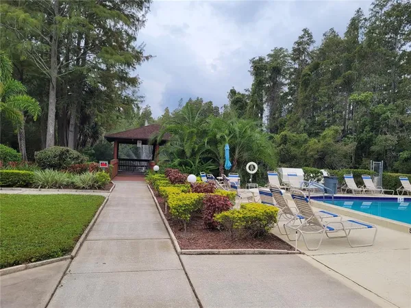 a view of a patio with chairs and a fire pit