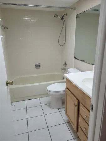 a bathroom with a granite countertop sink a toilet and shower