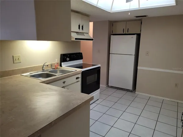 a kitchen with a sink appliances and cabinets