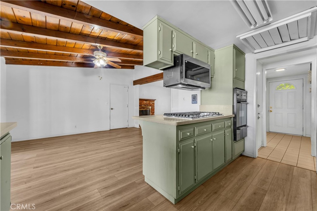 41852 Shain Lane Lancaster, CA 93536 - Photo 11 of 25 a kitchen with stainless steel appliances granite countertop a sink and dishwasher a stove top oven with wooden floor