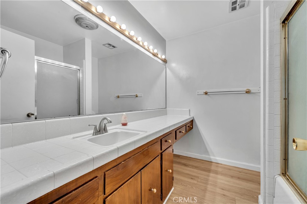 41852 Shain Lane Lancaster, CA 93536 - Photo 15 of 25 a bathroom with a sink and mirror