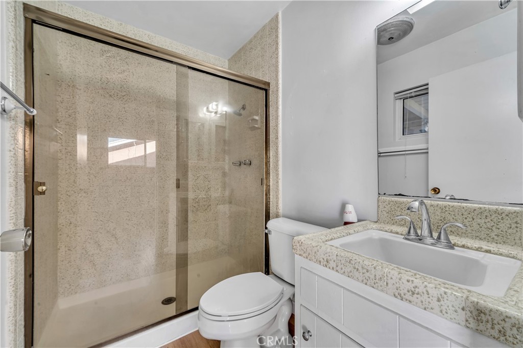 41852 Shain Lane Lancaster, CA 93536 - Photo 19 of 25 a bathroom with a granite countertop sink toilet and shower
