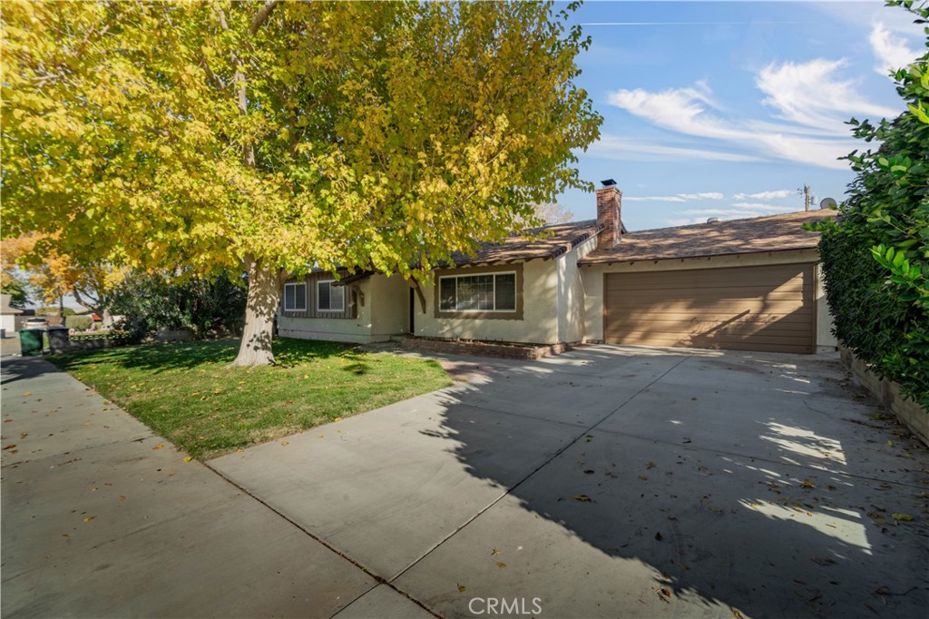 41852 Shain Lane Lancaster, CA 93536 - Photo 2 of 25 a front view of a house with a yard and a garage