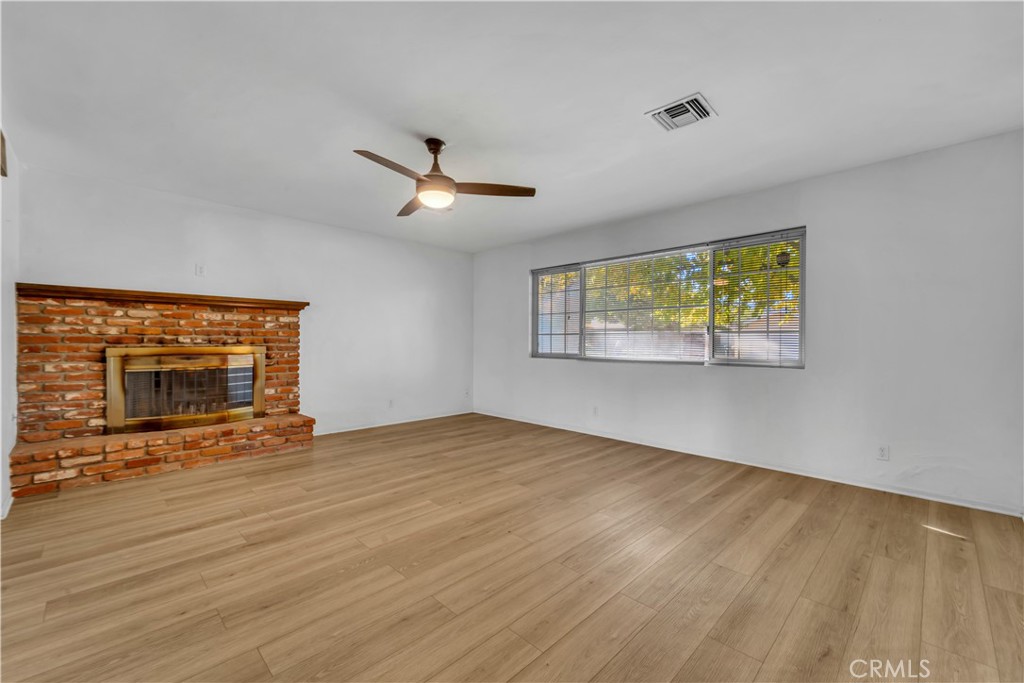 41852 Shain Lane Lancaster, CA 93536 - Photo 6 of 25 a view of an empty room with a fireplace and a window