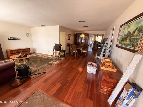 a living room with furniture and wooden floor