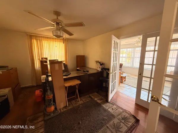a view of a workspace with furniture and a window
