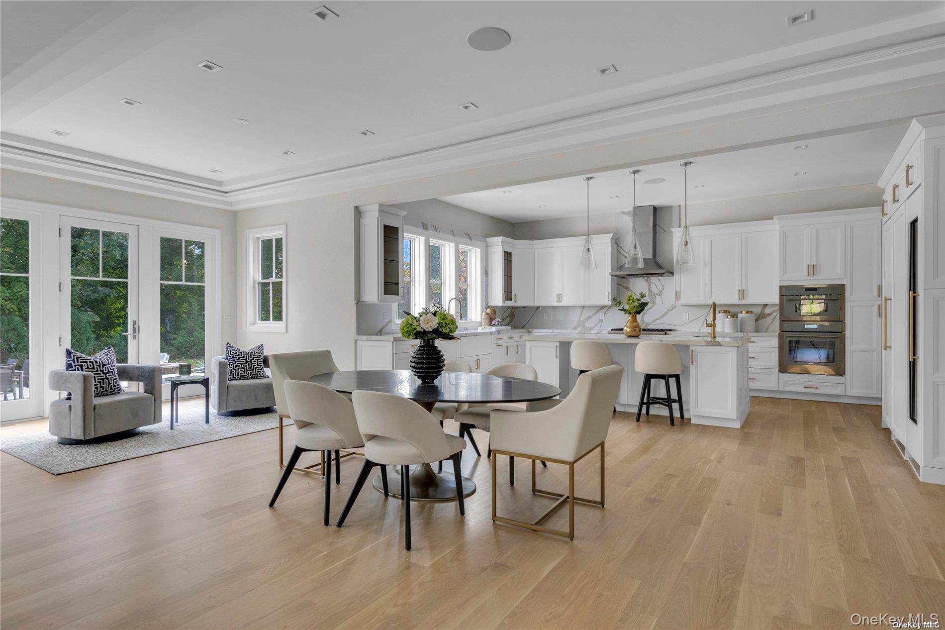 38 Cow Neck Road Sands Point, NY 11050 - Photo 11 of 48 a view of a dining room with furniture and a large window