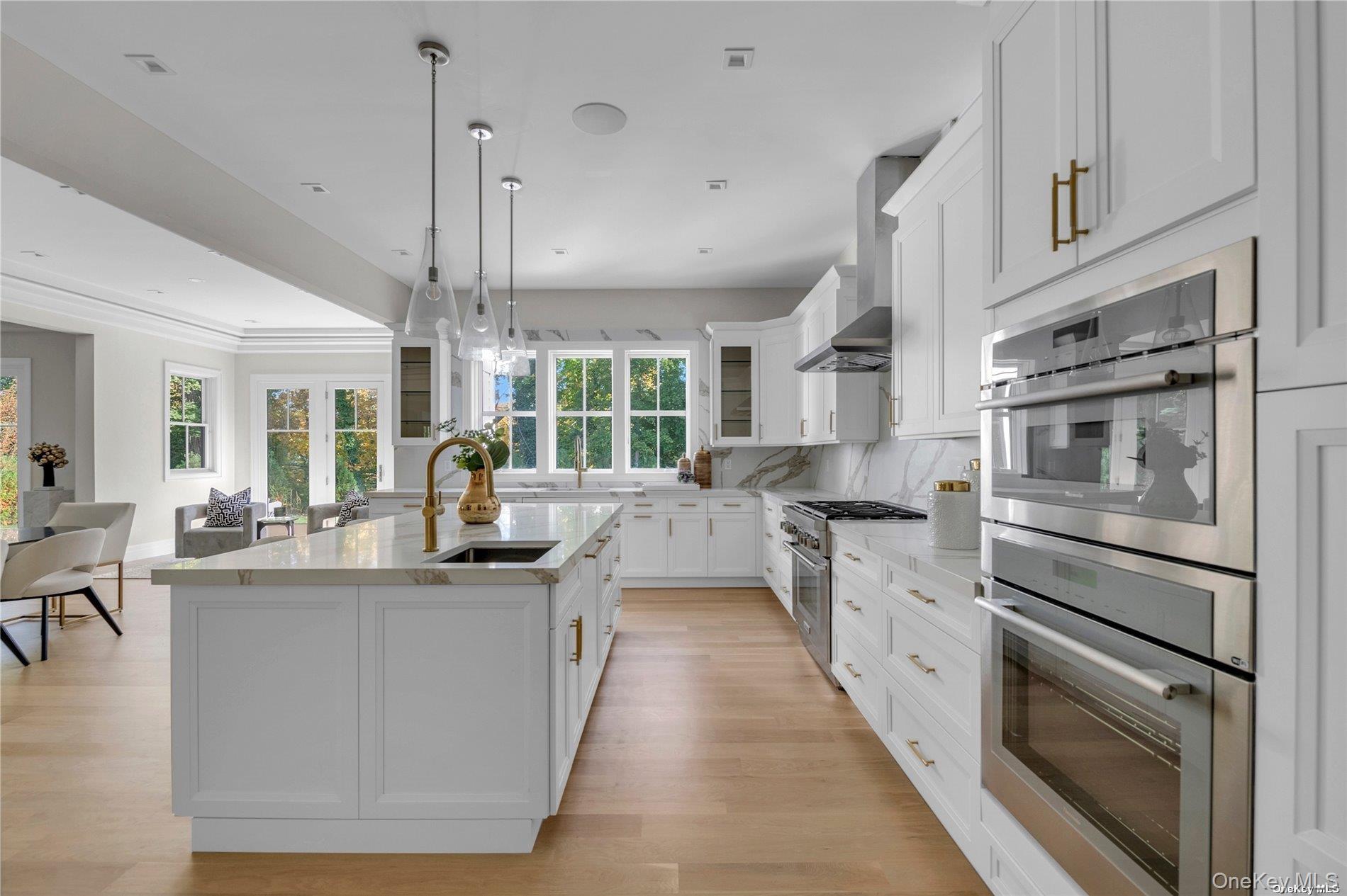 38 Cow Neck Road Sands Point, NY 11050 - Photo 12 of 48 a kitchen with stainless steel appliances kitchen island granite countertop a stove and a sink