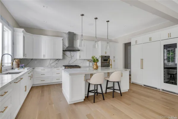 a kitchen with stainless steel appliances granite countertop a white cabinets and wooden floor
