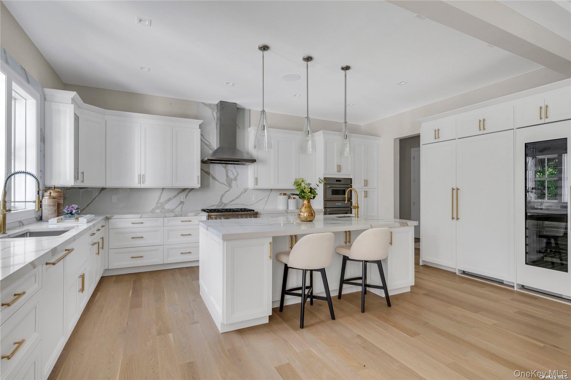 38 Cow Neck Road Sands Point, NY 11050 - Photo 13 of 48 a kitchen with stainless steel appliances granite countertop a white cabinets and wooden floor