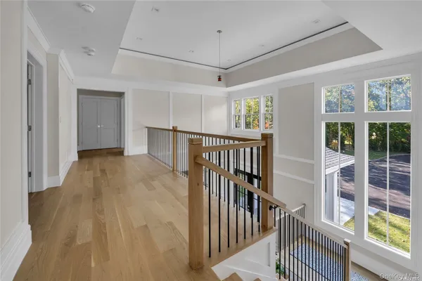a view of a hallway with wooden floor and entryway