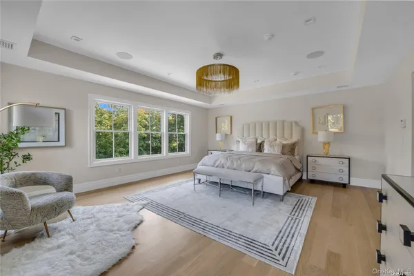 a bedroom with a large bed couch and a window