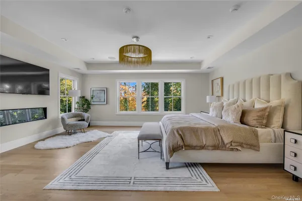 a spacious bedroom with a bed a couch and a window