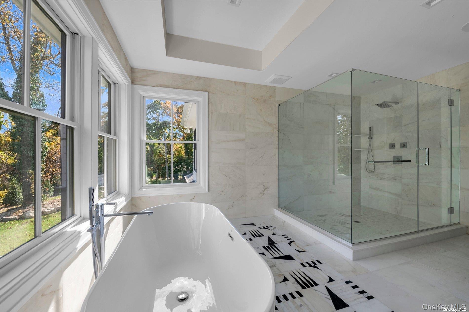38 Cow Neck Road Sands Point, NY 11050 - Photo 22 of 48 a bathroom with a bathtub and a shower