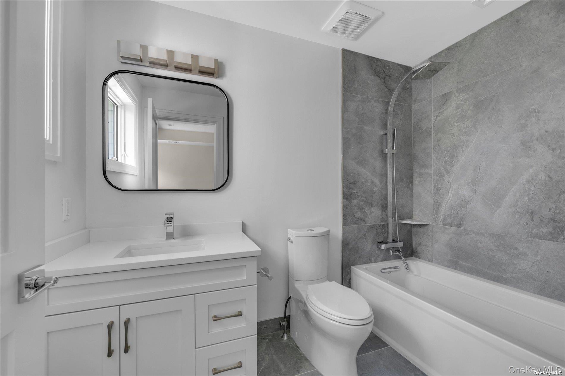 38 Cow Neck Road Sands Point, NY 11050 - Photo 28 of 48 a bathroom with a toilet sink and mirror