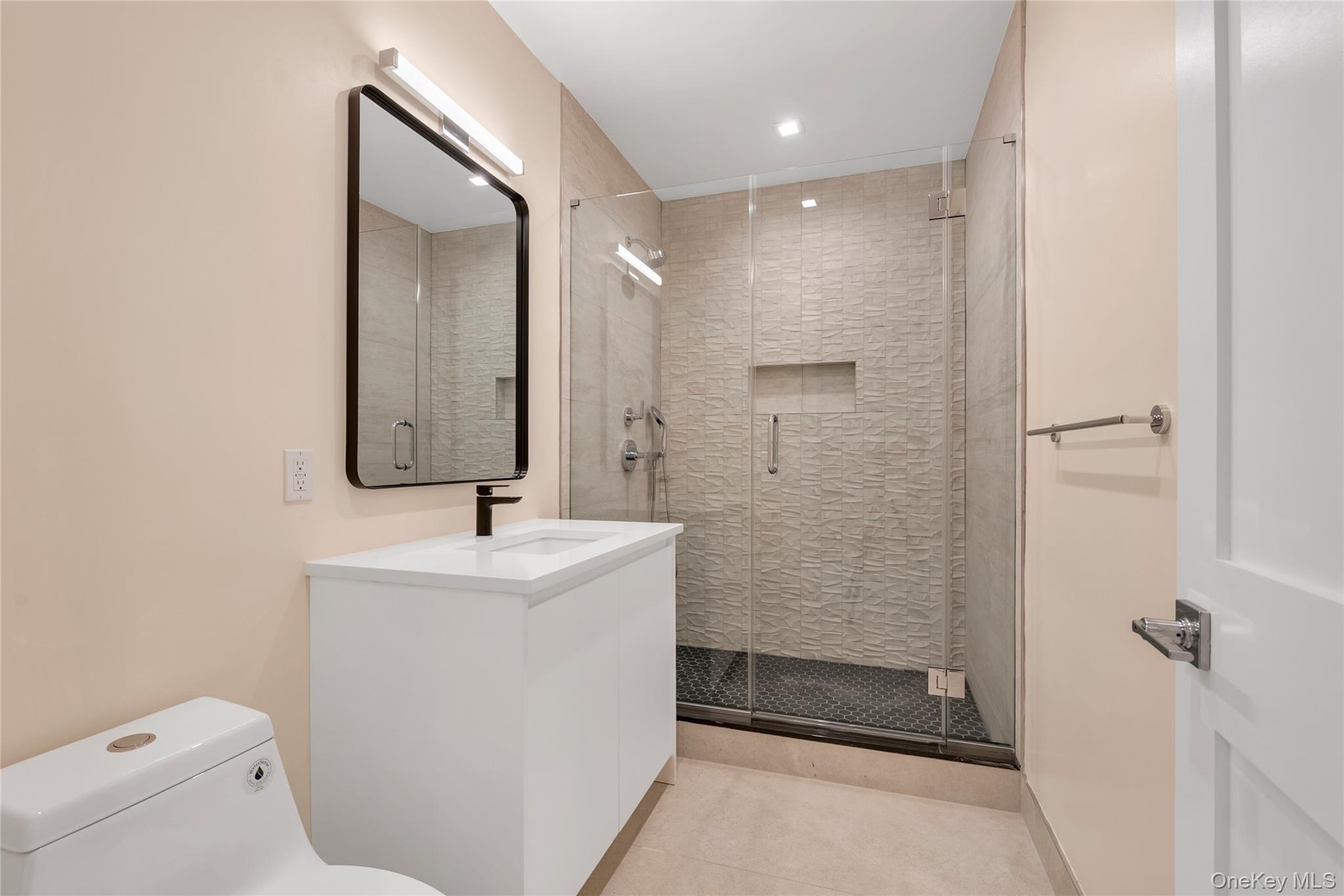 38 Cow Neck Road Sands Point, NY 11050 - Photo 29 of 48 a bathroom with a sink mirror toilet and shower