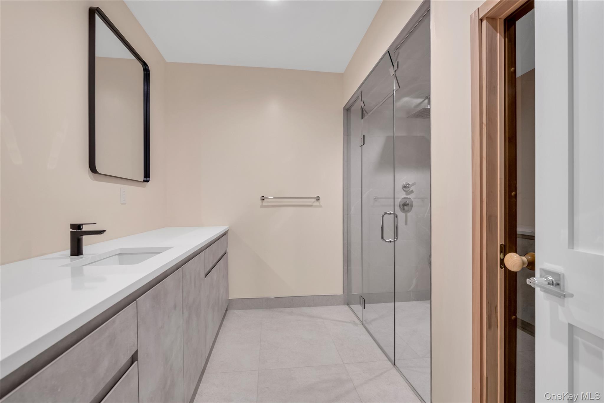 38 Cow Neck Road Sands Point, NY 11050 - Photo 31 of 48 a bathroom with a sink and a mirror