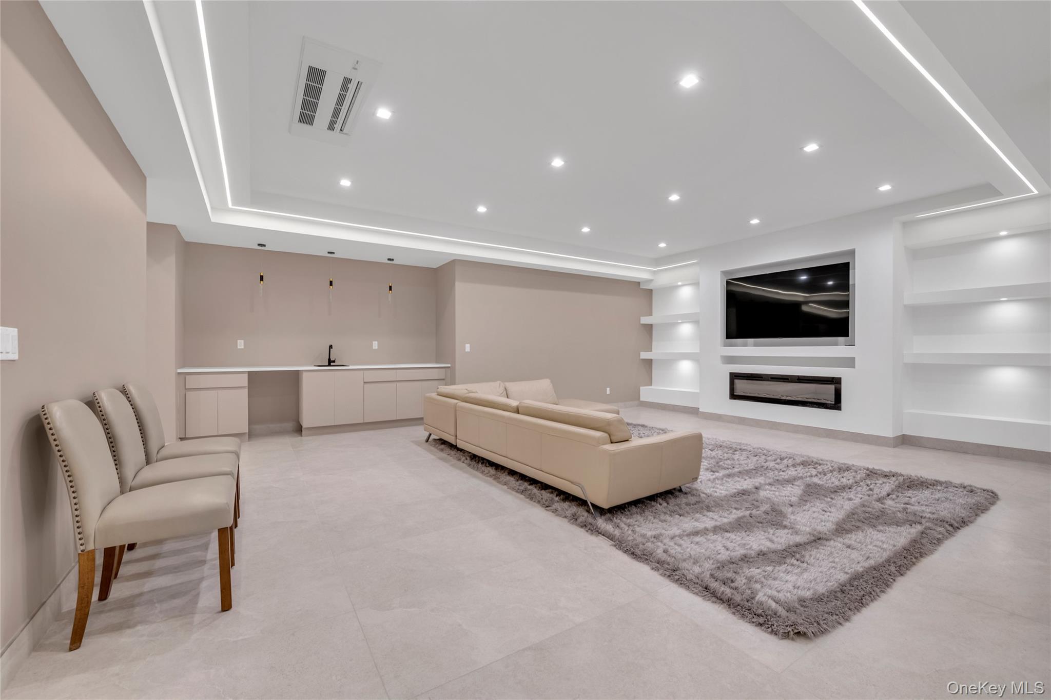 38 Cow Neck Road Sands Point, NY 11050 - Photo 35 of 48 a living room with furniture and a flat screen tv