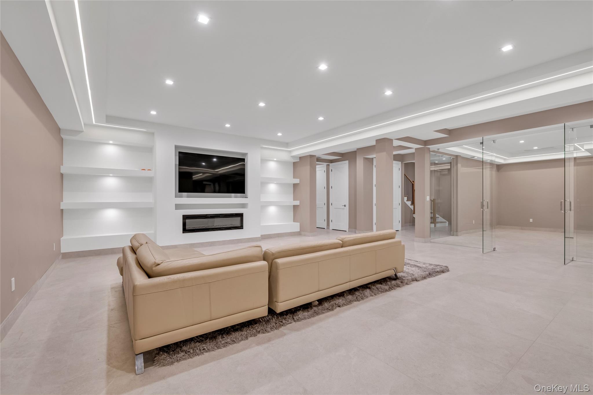 38 Cow Neck Road Sands Point, NY 11050 - Photo 39 of 48 a living room with furniture and a flat screen tv