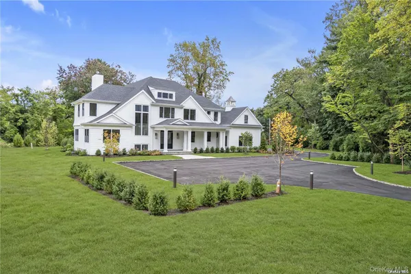 a front view of a house with swimming pool having outdoor seating
