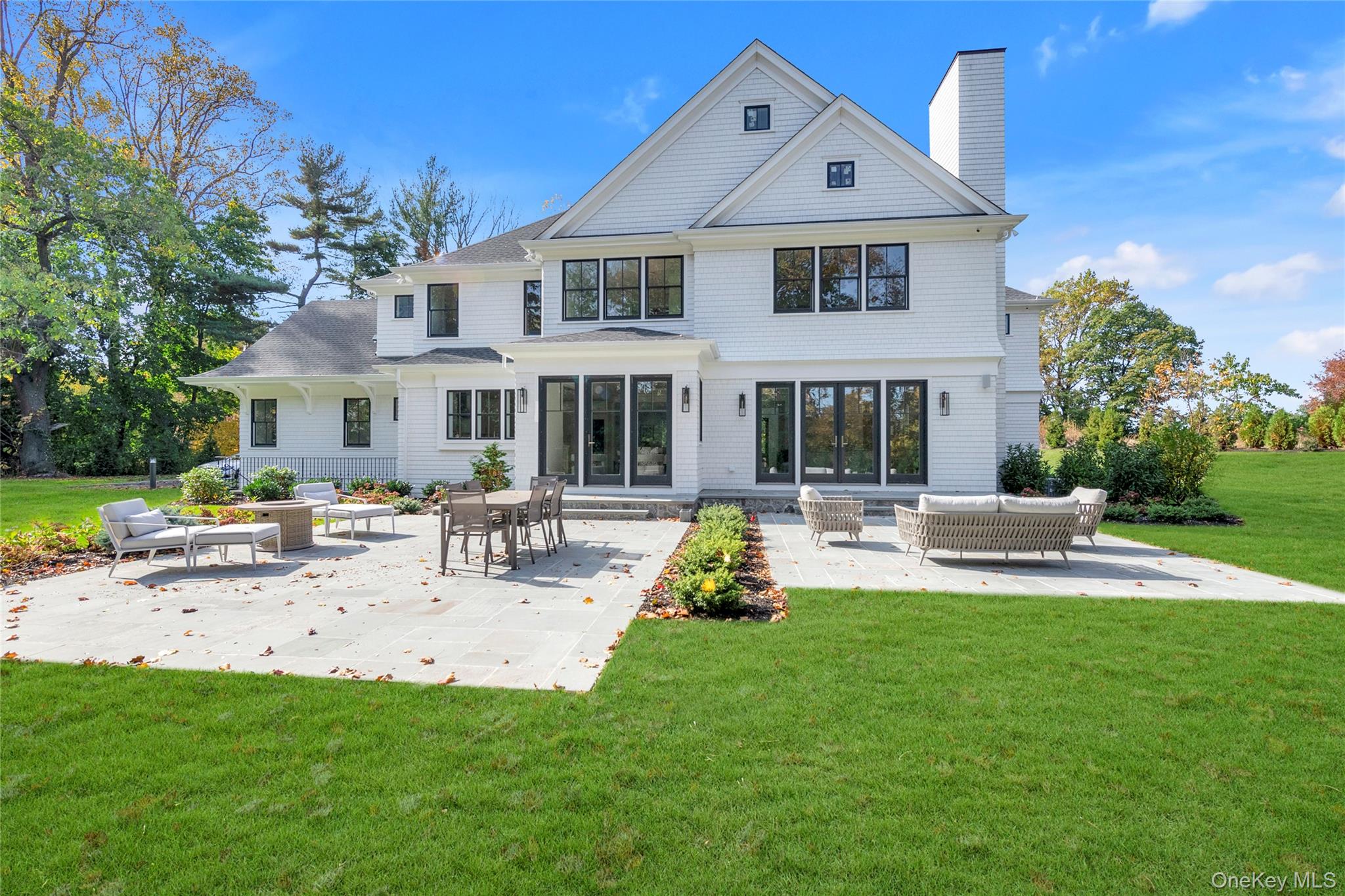 38 Cow Neck Road Sands Point, NY 11050 - Photo 44 of 48 a front view of a house with swimming pool having outdoor seating