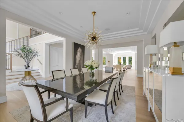 a view of a dining room with furniture and a chandelier