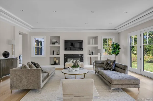 a living room with furniture fireplace and a window