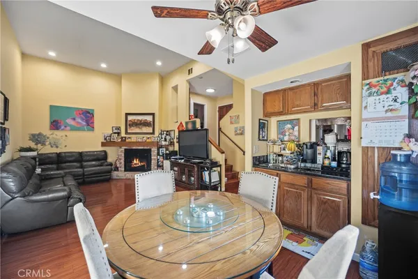 a dining room with wooden floor a chandelier a wooden table and chairs