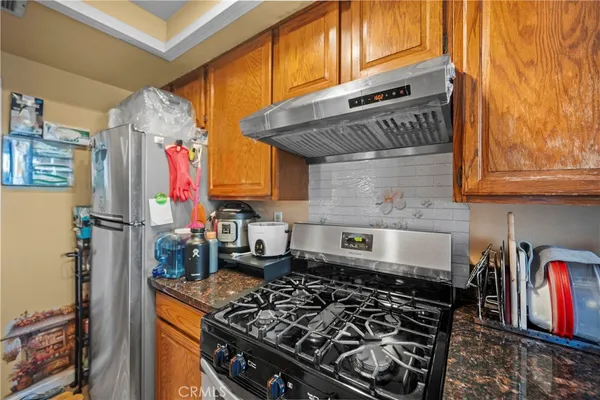 a kitchen with stove and cabinets